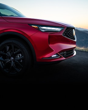 2024 Acura MDX A-Spec in Performance Red Pearl profile parked on a mountain road at sunset (Premium Performance SUV). 2024 Acura MDX A-Spec in Performance Red Pearl profile parked on a mountain road at sunset (Premium Performance SUV).